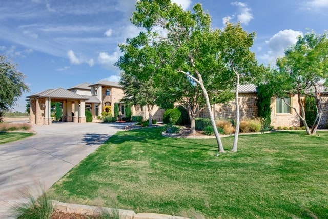 view of front of home with a front lawn and a gazebo