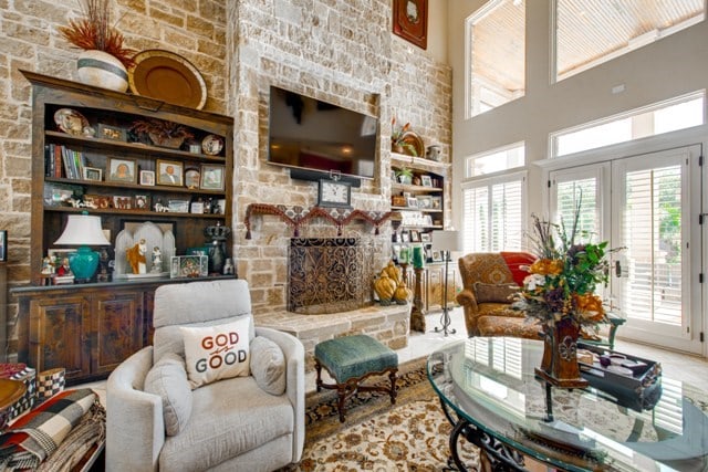 living room featuring a fireplace and a high ceiling