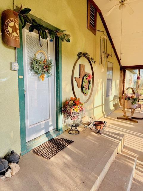 5038 N Sullivan Rd, Fort Stockton, TX 79735 - doorway to property featuring stucco siding and a porch