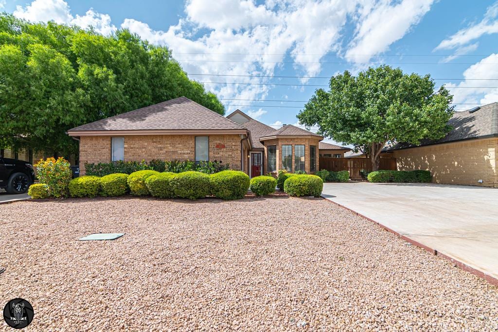 5202 Green Tree Blvd, Midland, TX 79707 - single story home featuring brick siding and roof with shingles