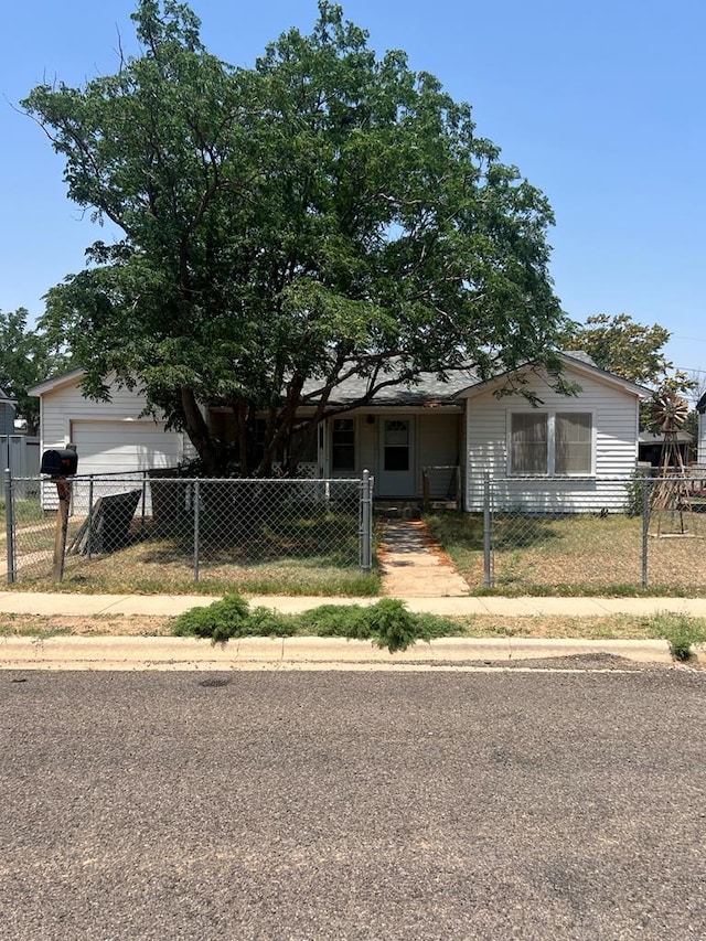 205 Jefferson St, Big Spring, TX 79720 - view of front of home with a fenced front yard, a garage, and a gate