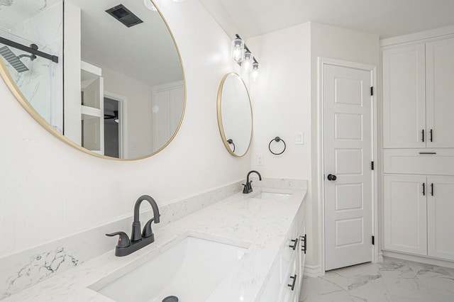 full bathroom with marble finish floor, visible vents, a sink, and double vanity