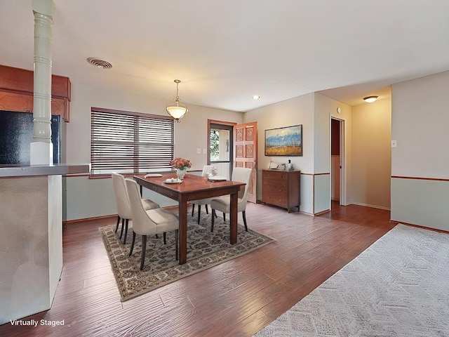 dining space featuring wood-type flooring