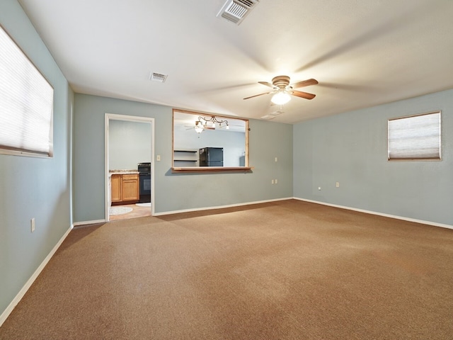 carpeted spare room featuring ceiling fan