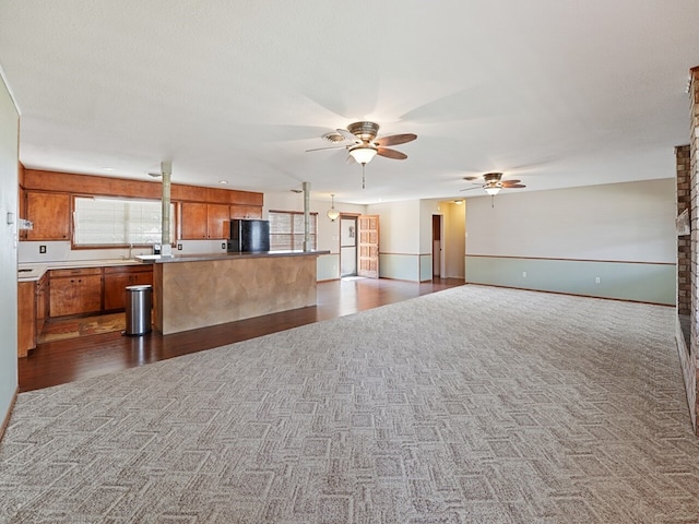 kitchen featuring carpet, black refrigerator, a textured ceiling, and ceiling fan