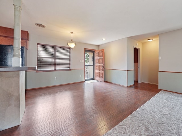 unfurnished living room with hardwood / wood-style flooring