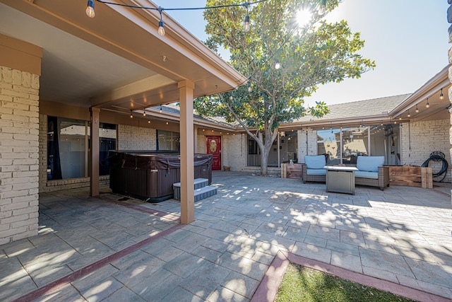 view of patio / terrace featuring an outdoor living space and a hot tub