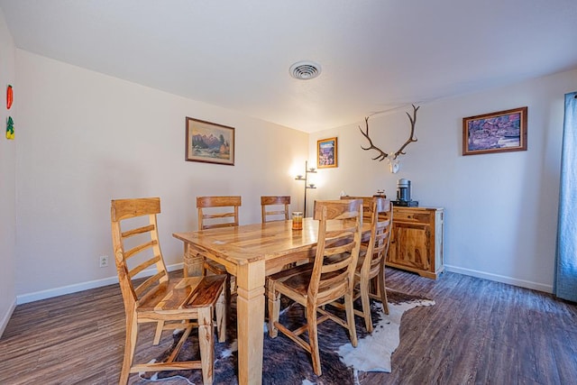 dining area with dark hardwood / wood-style floors