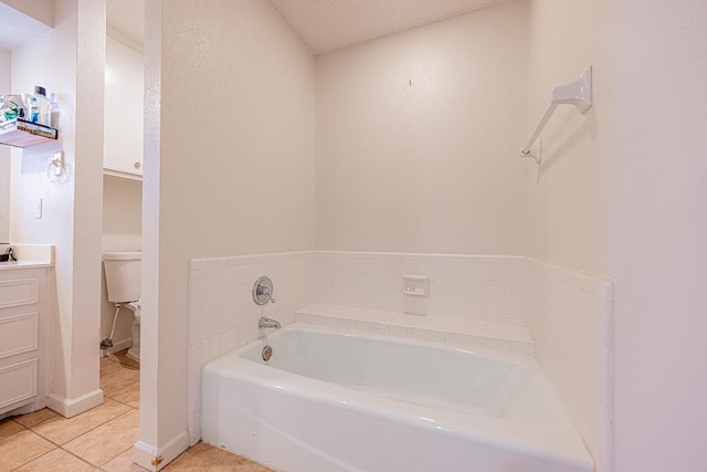 bathroom with tile patterned flooring, vanity, a tub, and toilet