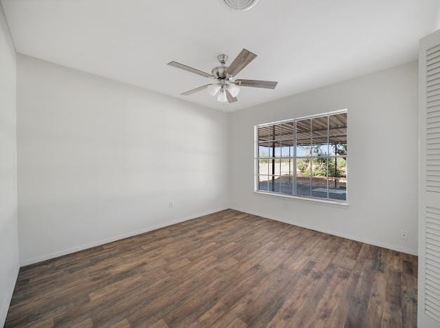 empty room featuring dark hardwood / wood-style flooring and ceiling fan