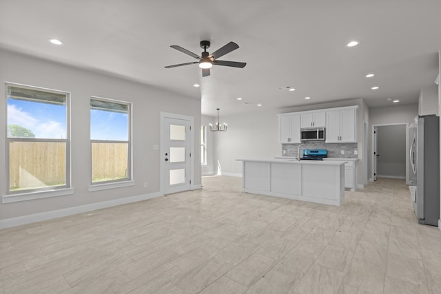 2710 Beachwood St, Midland, TX 79706 - kitchen featuring stainless steel appliances, a ceiling fan, backsplash, open floor plan, and recessed lighting