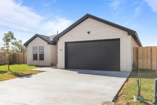 2710 Beachwood St, Midland, TX 79706 - ranch-style home with brick siding, an attached garage, and concrete driveway