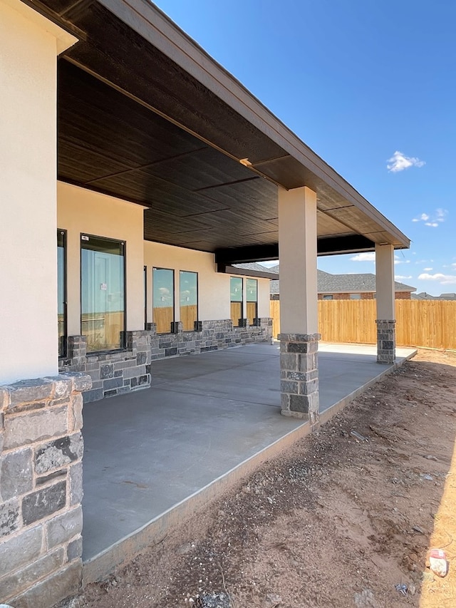 view of patio featuring fence