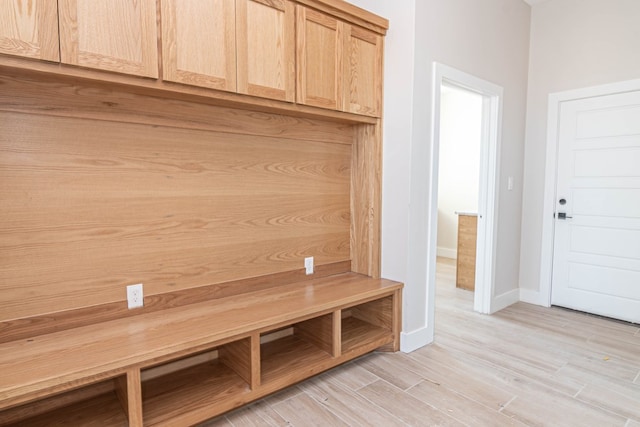 mudroom featuring light wood-style floors and baseboards