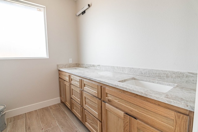 bathroom featuring baseboards and wood finished floors