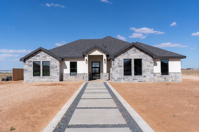 2209 S County Rd 1059, Midland, TX 79706 - view of front of house with stone siding, roof with shingles, and stucco siding