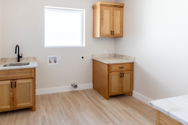 2209 S County Rd 1059, Midland, TX 79706 - washroom featuring washer hookup, hookup for an electric dryer, light wood-style flooring, and baseboards
