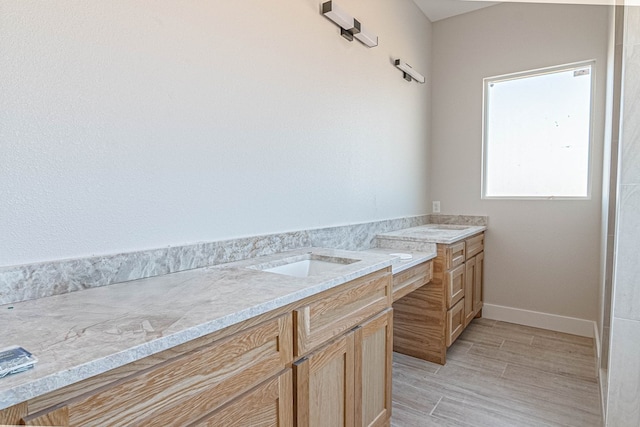 bathroom featuring vanity and wood finished floors