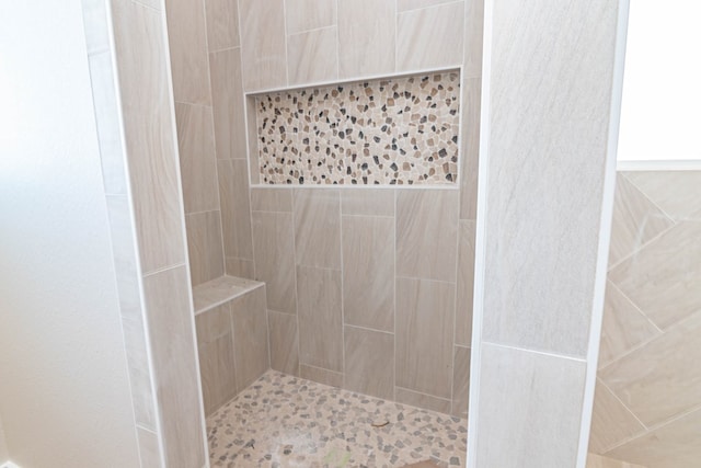 bathroom with a tile shower