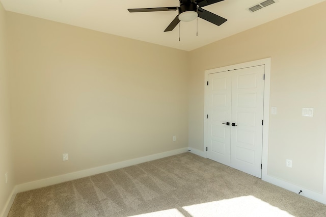 2209 S County Rd 1059, Midland, TX 79706 - unfurnished bedroom with carpet flooring, a closet, baseboards, and a ceiling fan