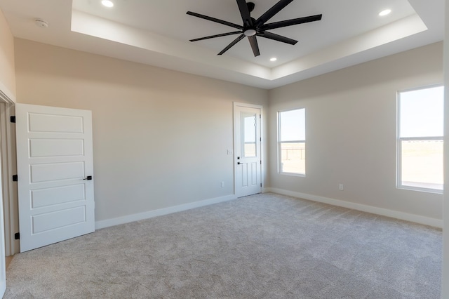 2209 S County Rd 1059, Midland, TX 79706 - spare room featuring a tray ceiling, a ceiling fan, carpet floors, recessed lighting, and baseboards
