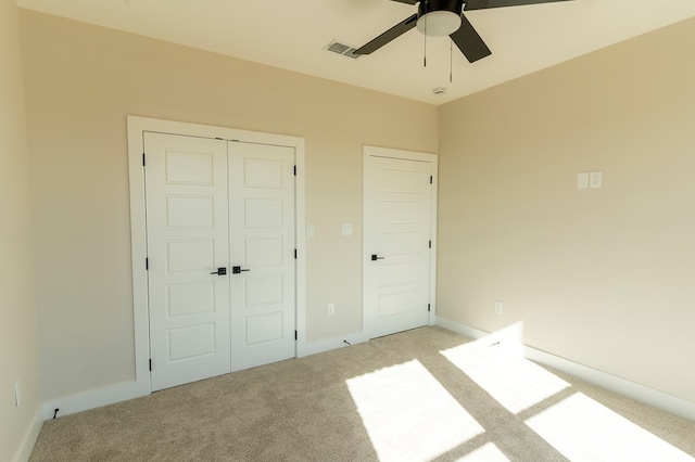2209 S County Rd 1059, Midland, TX 79706 - unfurnished bedroom featuring light carpet, a closet, baseboards, and a ceiling fan