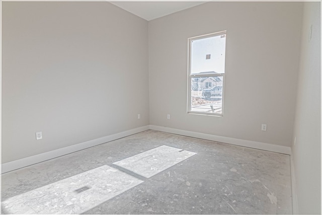 unfurnished room featuring baseboards