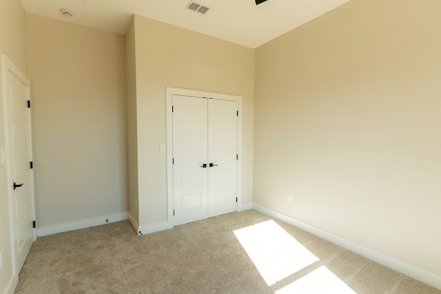 2209 S County Rd 1059, Midland, TX 79706 - unfurnished bedroom featuring light carpet, a closet, and baseboards