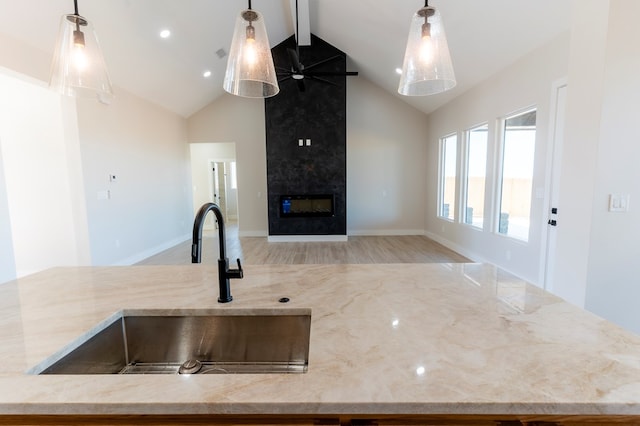 2209 S County Rd 1059, Midland, TX 79706 - kitchen featuring open floor plan, a sink, beamed ceiling, high vaulted ceiling, and light stone counters