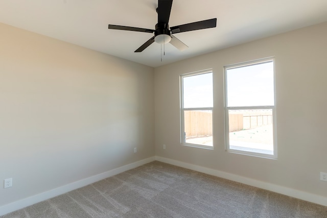 2209 S County Rd 1059, Midland, TX 79706 - spare room with healthy amount of natural light, light carpet, baseboards, and ceiling fan