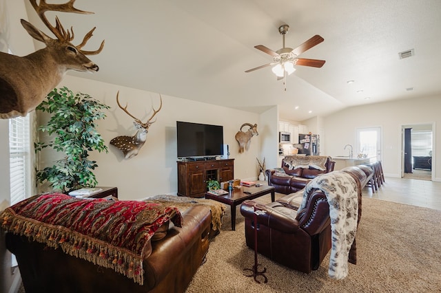 living room with visible vents, baseboards, lofted ceiling, light tile patterned flooring, and ceiling fan