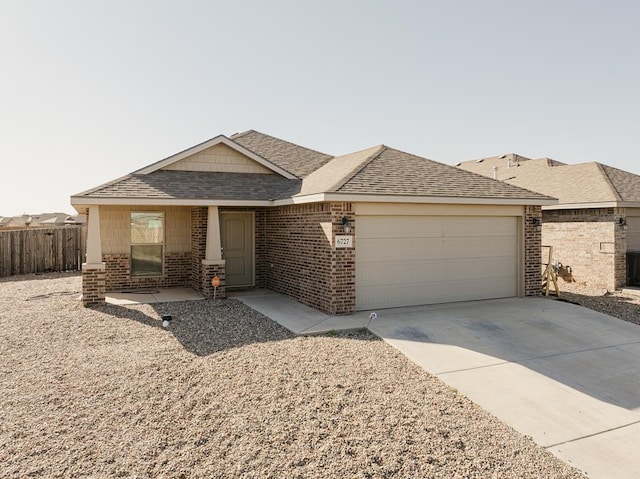 single story home with fence, roof with shingles, concrete driveway, a garage, and brick siding