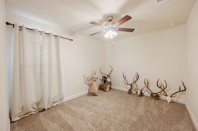 unfurnished room featuring a ceiling fan, carpet flooring, visible vents, and baseboards