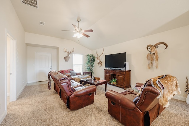 living area with visible vents, lofted ceiling, carpet floors, baseboards, and ceiling fan