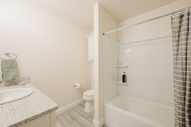 full bath with vanity, wood finished floors, baseboards, shower / bath combination with curtain, and toilet