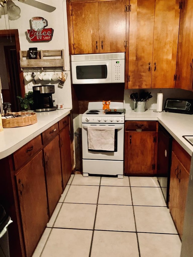 kitchen with white appliances, light countertops, and light tile patterned floors