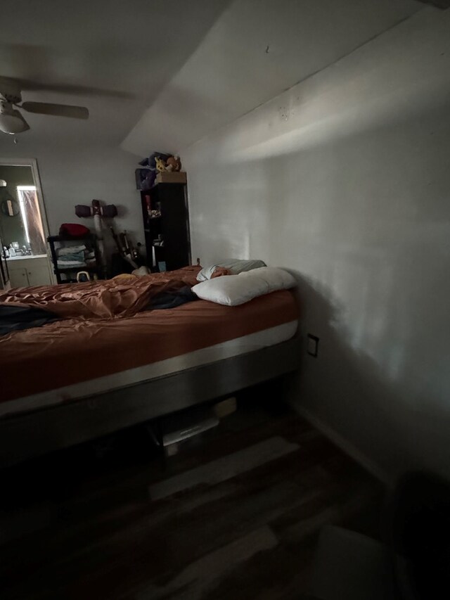 bedroom featuring lofted ceiling, wood finished floors, and ceiling fan