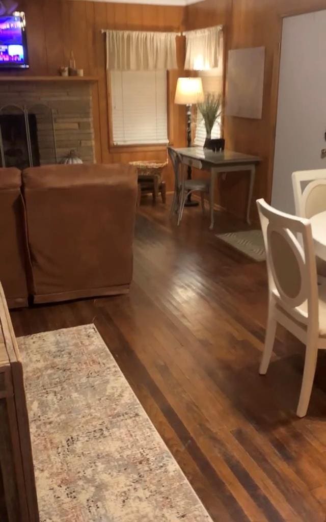 living room featuring wood finished floors and wood walls