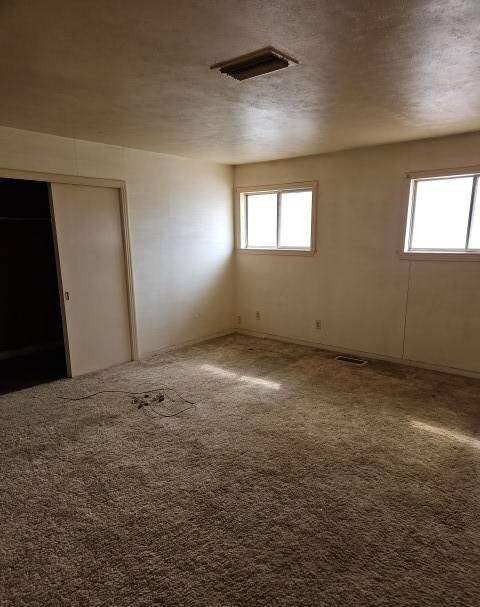 carpeted spare room with visible vents