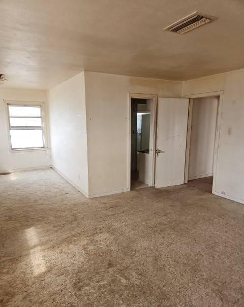 spare room with visible vents and baseboards