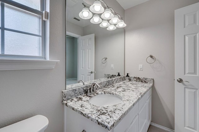 5706 Devlin Pl, Midland, TX 79707 - half bathroom with vanity, plenty of natural light, and toilet