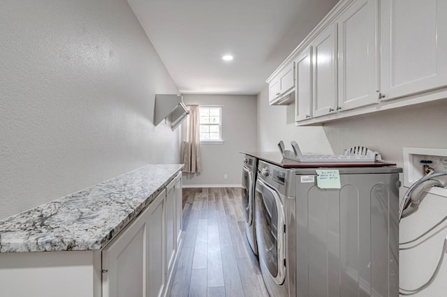 5706 Devlin Pl, Midland, TX 79707 - laundry area with cabinet space, light wood-style flooring, washer and dryer, baseboards, and recessed lighting