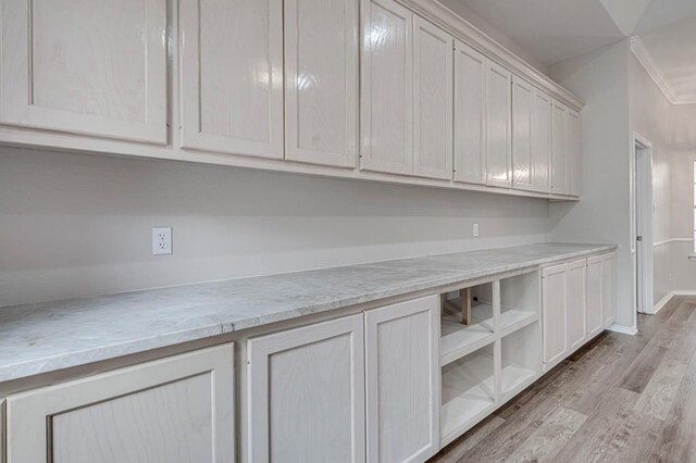 5706 Devlin Pl, Midland, TX 79707 - kitchen with light wood-style floors and crown molding