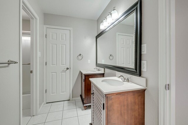 5706 Devlin Pl, Midland, TX 79707 - full bathroom featuring two vanities and tile patterned floors