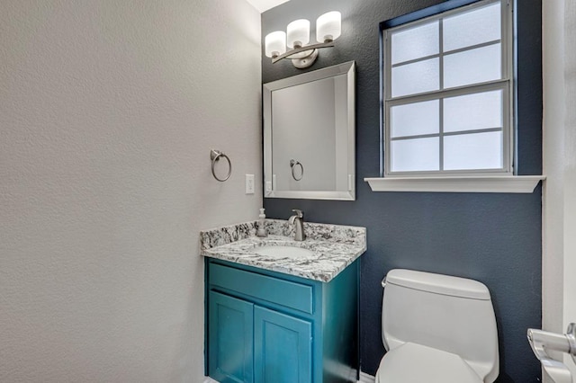 5706 Devlin Pl, Midland, TX 79707 - bathroom with toilet, vanity, and a textured wall
