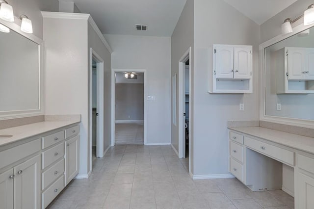 5706 Devlin Pl, Midland, TX 79707 - bathroom featuring vanity, tile patterned flooring, baseboards, and vaulted ceiling