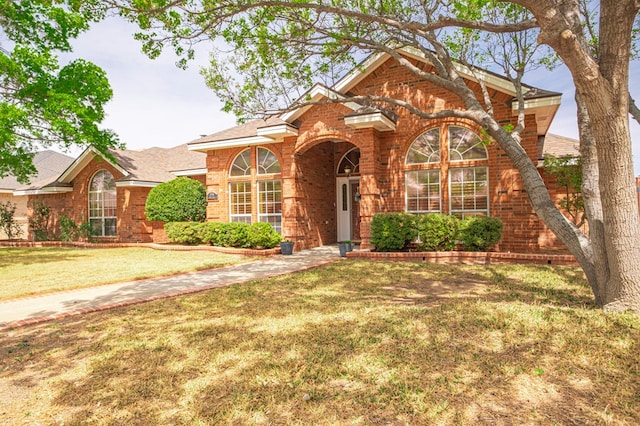 5706 Devlin Pl, Midland, TX 79707 - traditional home featuring brick siding, a front lawn, and roof with shingles