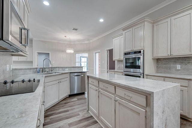5706 Devlin Pl, Midland, TX 79707 - kitchen featuring appliances with stainless steel finishes, a sink, light wood-style floors, a peninsula, and backsplash