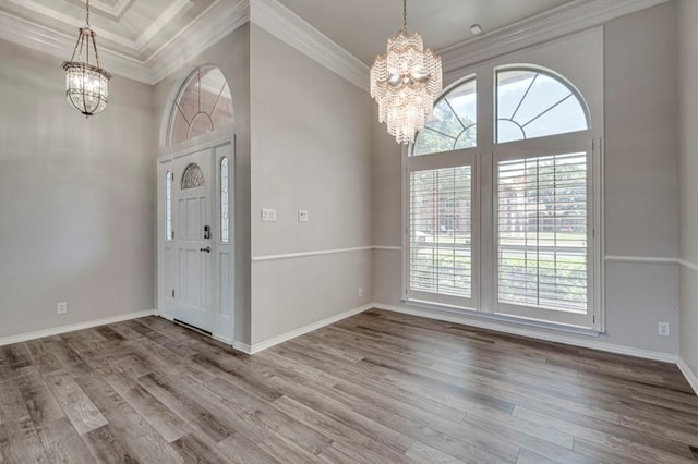 5706 Devlin Pl, Midland, TX 79707 - foyer entrance with a chandelier, crown molding, wood finished floors, baseboards, and a towering ceiling