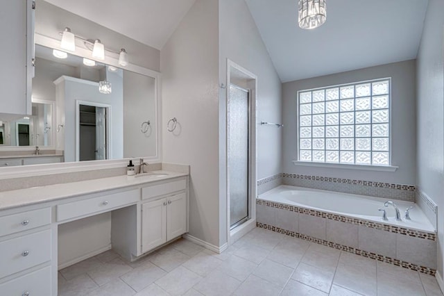 5706 Devlin Pl, Midland, TX 79707 - full bath with lofted ceiling, vanity, a garden tub, tile patterned flooring, and a shower stall